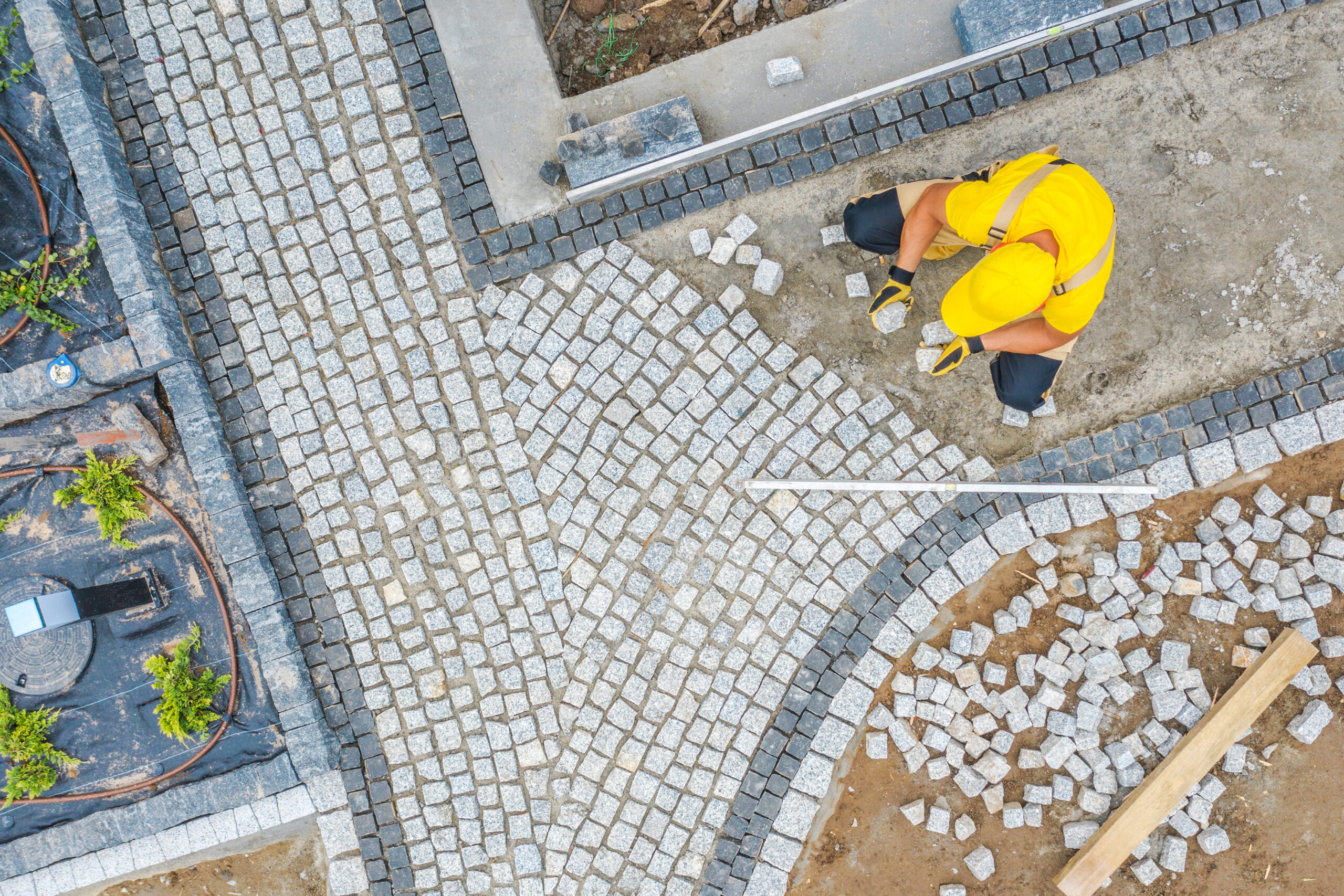 Worker Paving Garden Path Aerial Vista